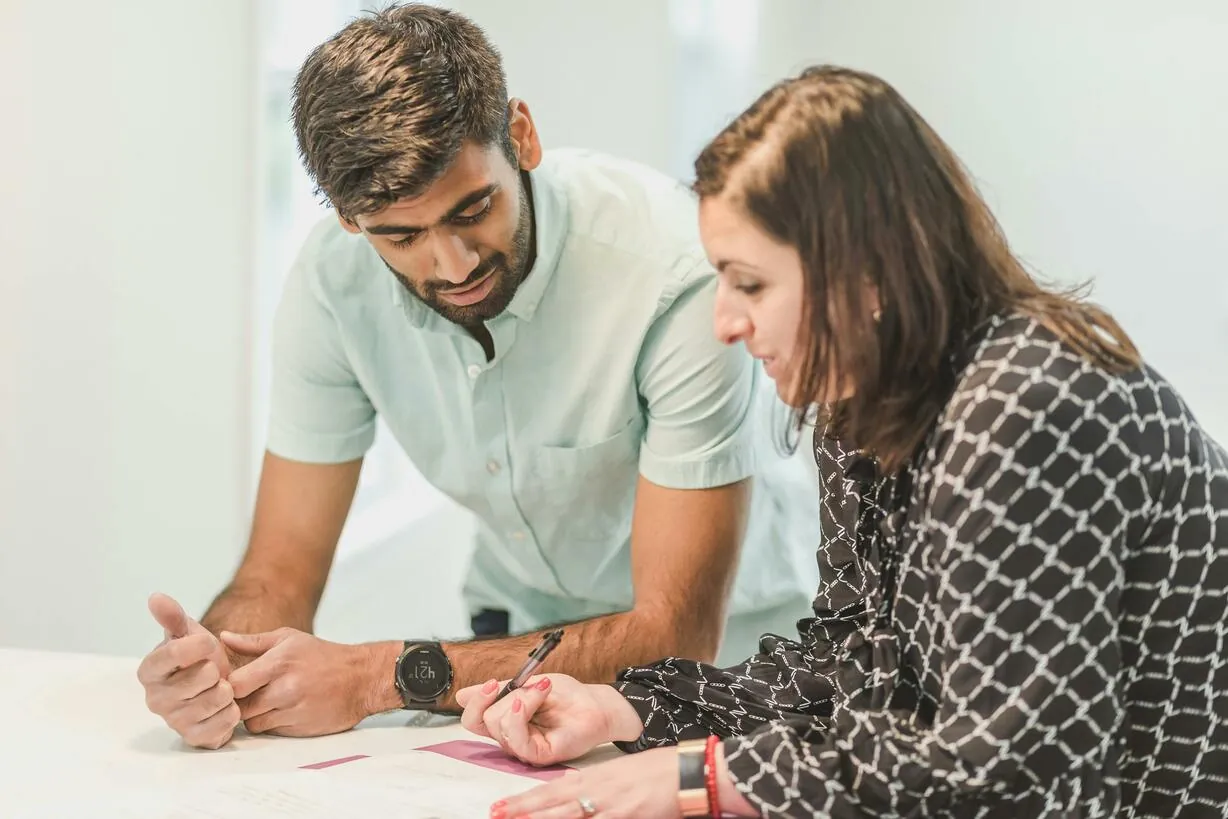 A real estate agent assisting a client with home-buying paperwork